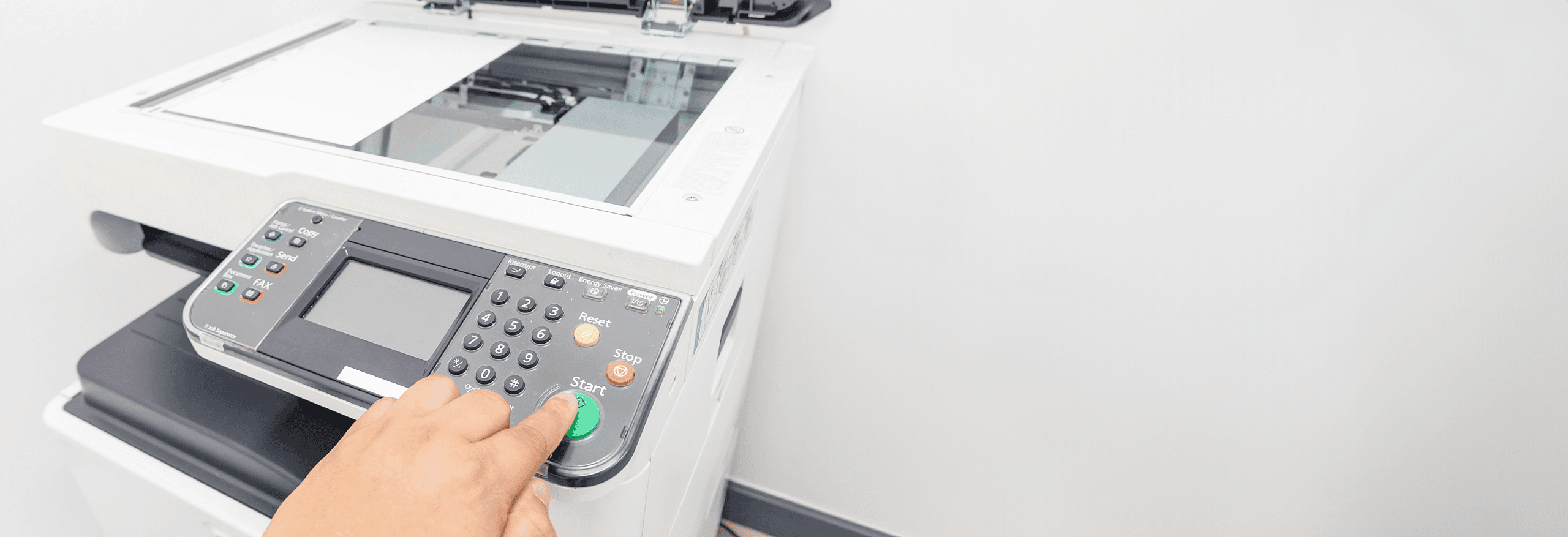 Business professional using a high-end commercial copier. Explore cost-effective leasing options for office photocopiers and equipment upgrades with grenke.