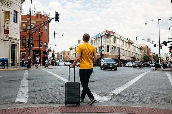 Man at crossroads with luggage